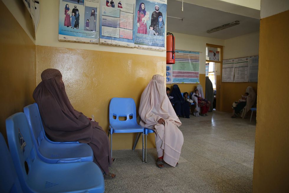 Women wait to see a doctor at the health clinic in Khoshab area, next to Kandahar airfield.