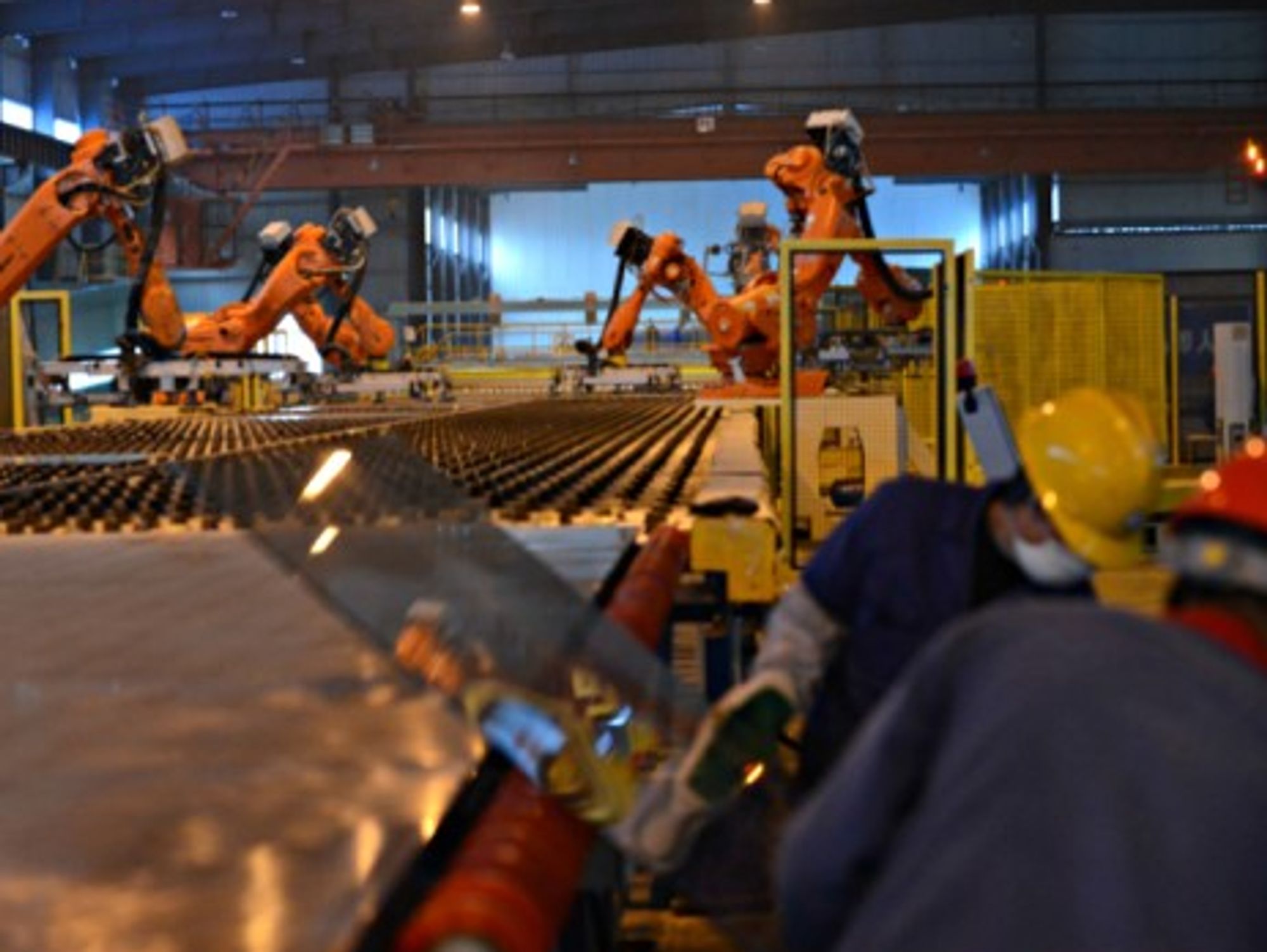 Workers and robots on a production line in Zhangshu, eastern China