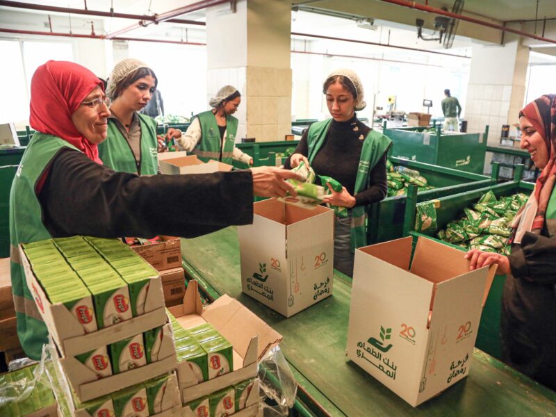 Workers and volunteers work to prepare free food boxes at the Egyptian Food Bank in Cairo, Egypt.​