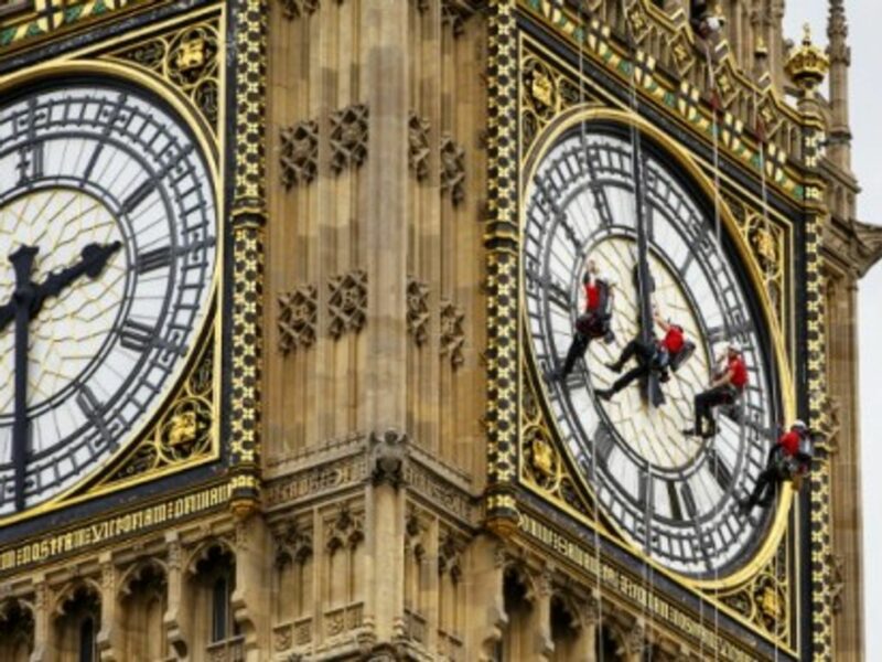 Workers clean the clock face of Elizabeth Tower, which houses Big Ben, in London yesterday.