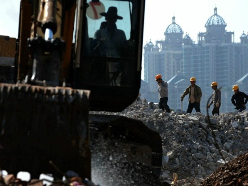 Workers dismantle buildings in Guangzhou