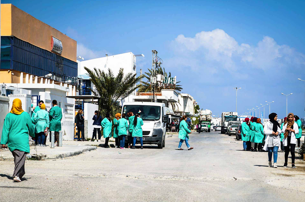 Workers on their lunch break in front of one of the many businesses located along the Boulevard de l'environnement, which runs through the southern suburbs of Monastir.