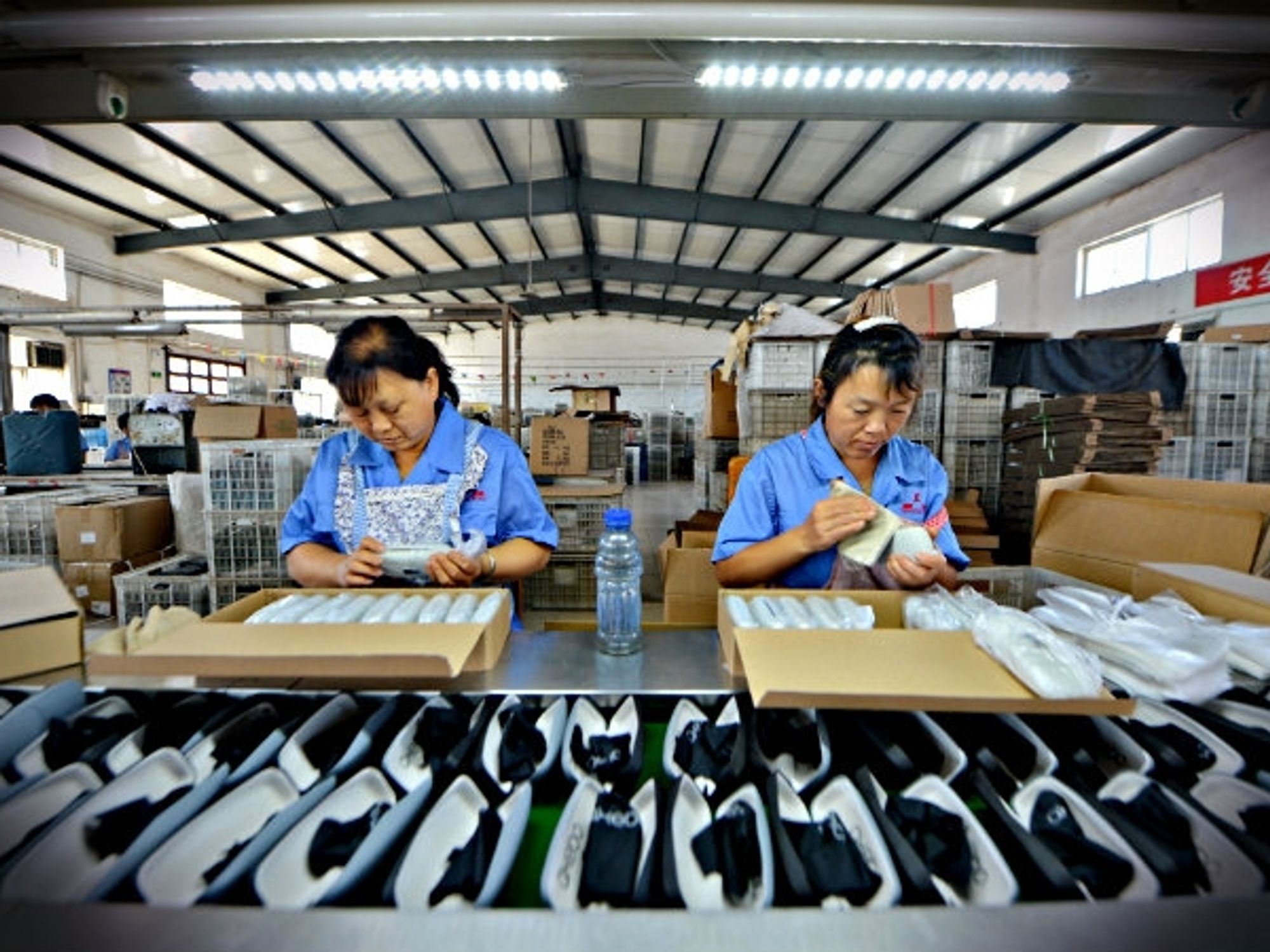 Workers producing glasses cases in a factory in Hebei Province