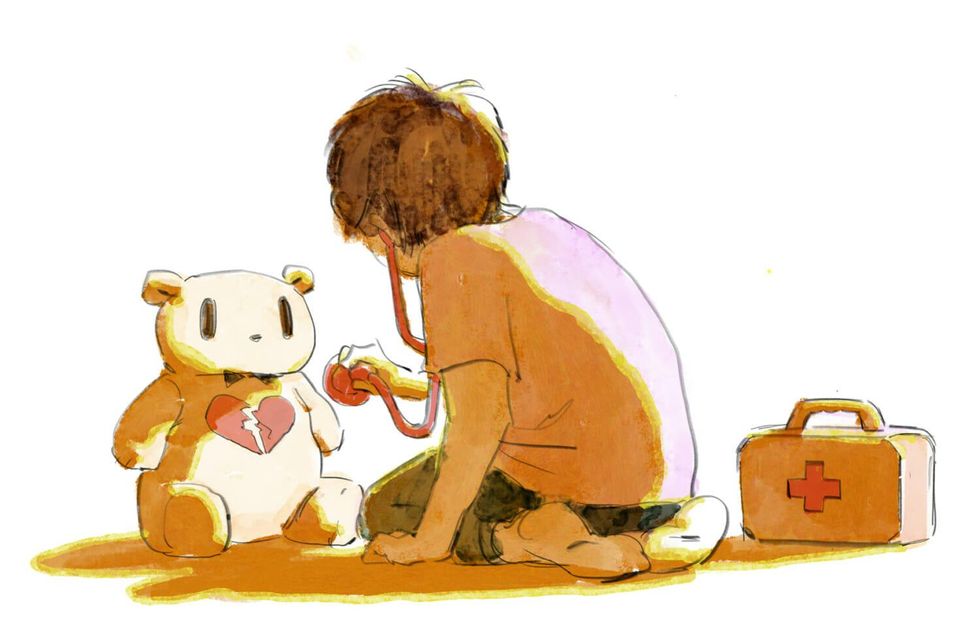 Young boy playing doctor with the bear