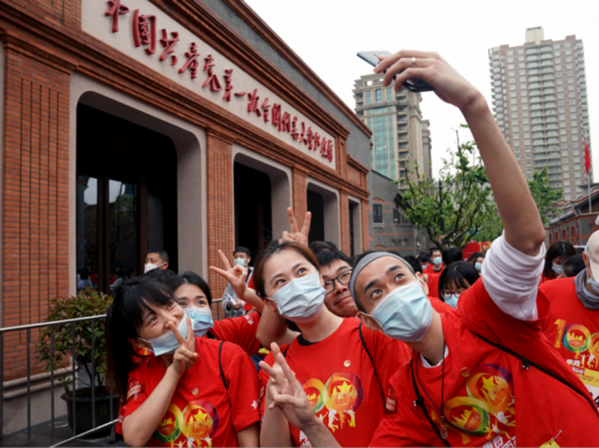 Young people pose for photos at the site of the first National Congress of the Communist Party of China in Shanghai