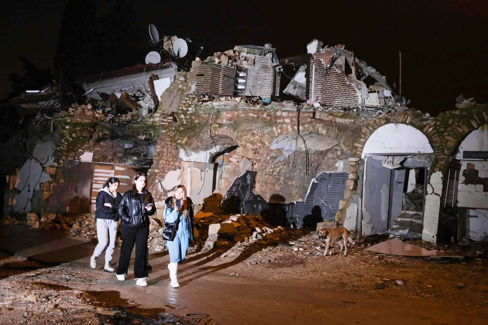 Young people walk through the earthquake debris to commemorate those who lost their lives in the earthquake.
