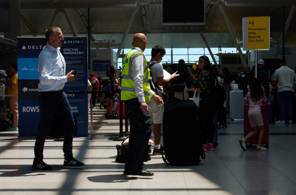 Photo of security and travelers at NYC's JFK airport