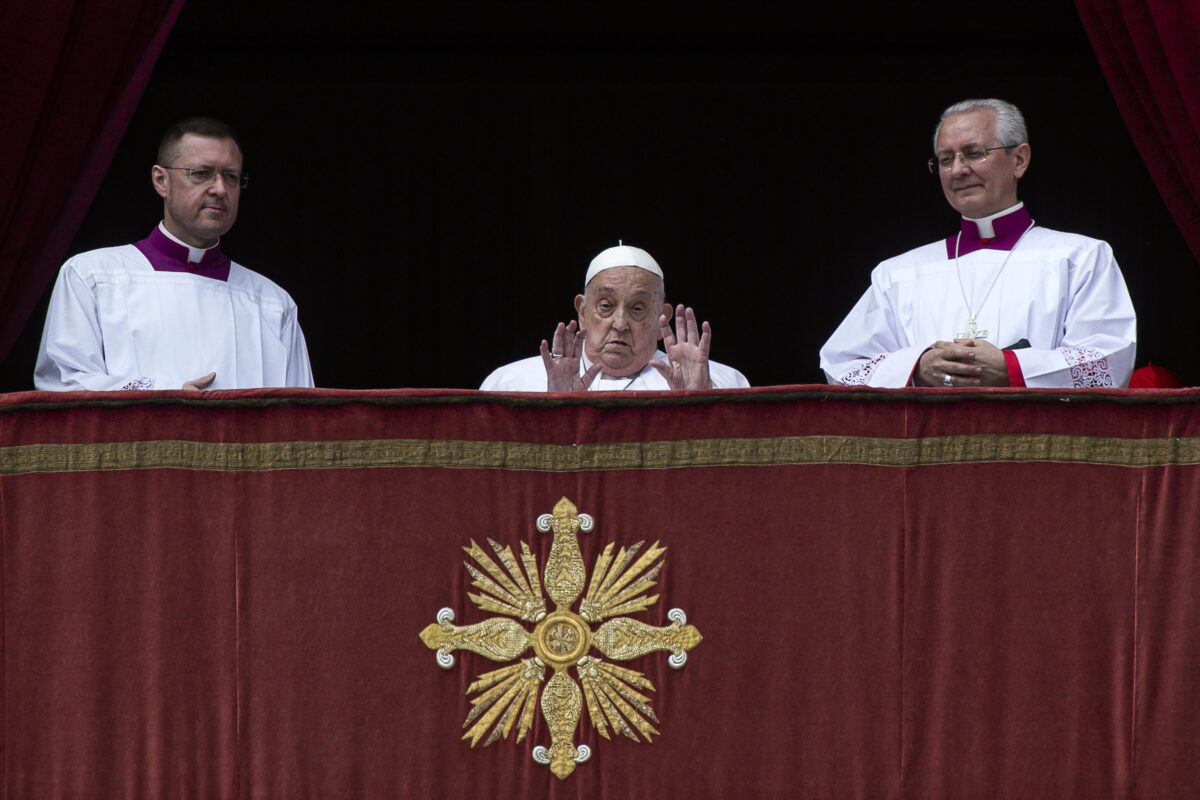 Pope Francis sits on a balcony at the Vatican on Easter Sunday.