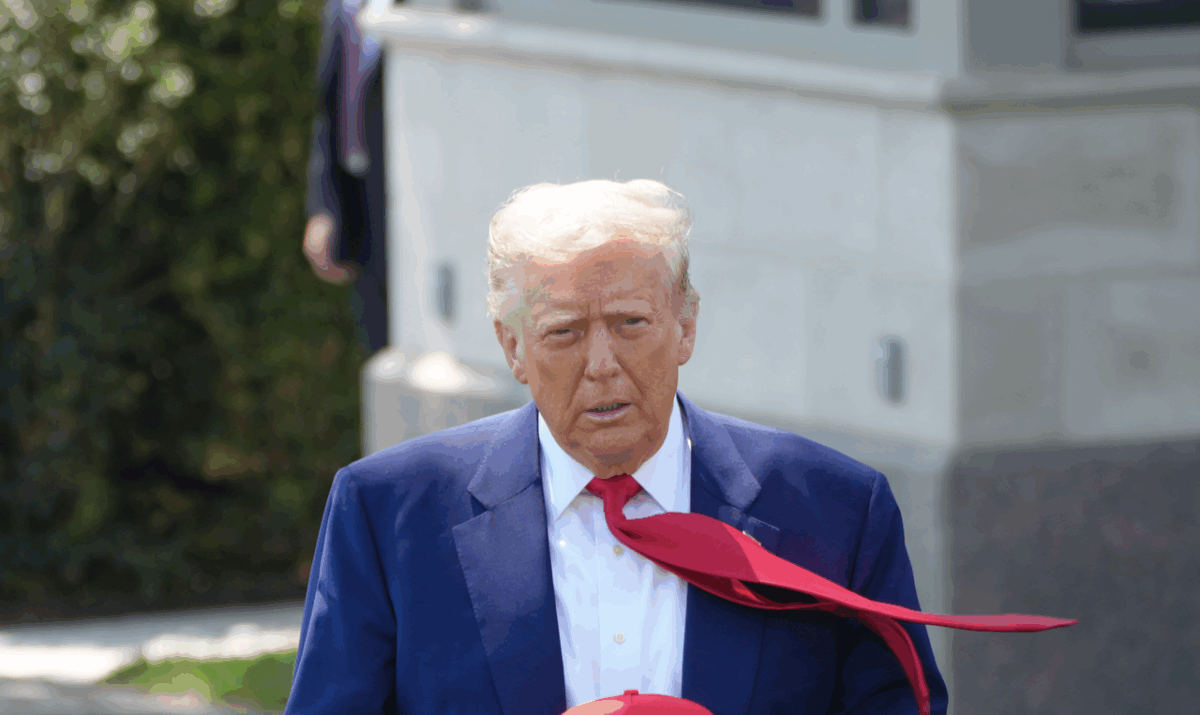 Photo of U.S. President Donald Trump wearing a blue suit and a red tie.