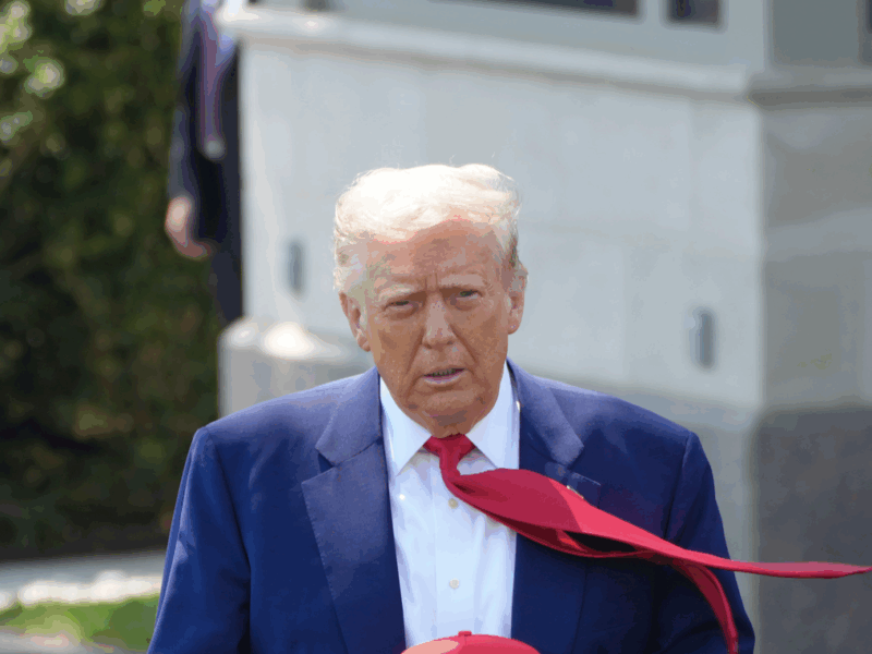 Photo of U.S. President Donald Trump wearing a blue suit and a red tie.