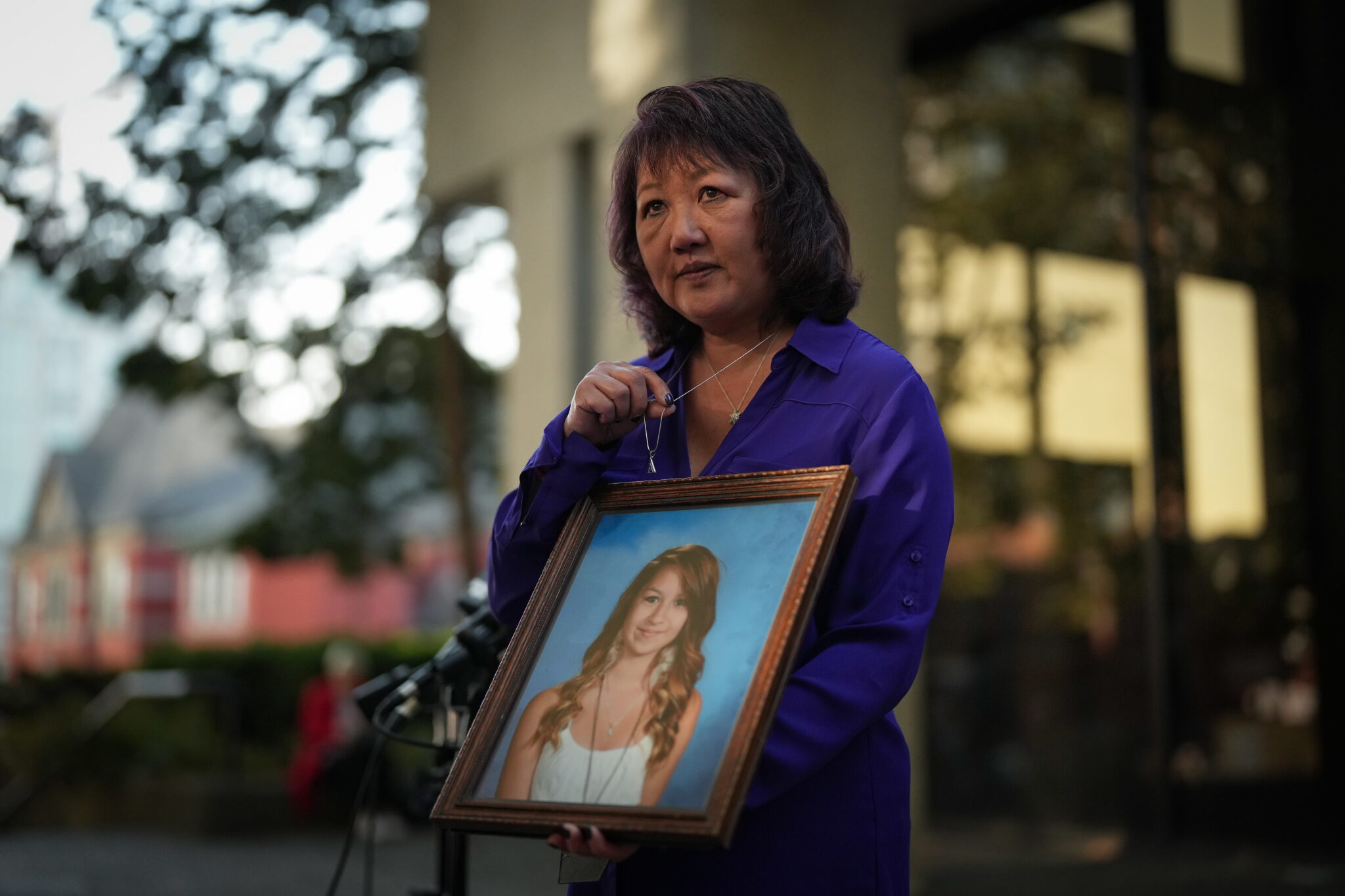 Carol Todd holding portrait of daughter Amanda Todd