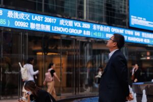 Photo of a man in Hong Kong looking at stock prices