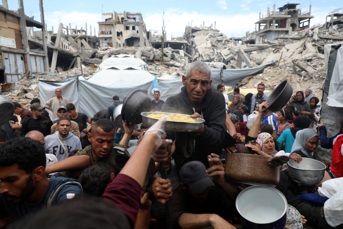 Palestinians receive free food from a food distribution center in the town of Beit Lahia, northern Gaza, on April 27, 2025.