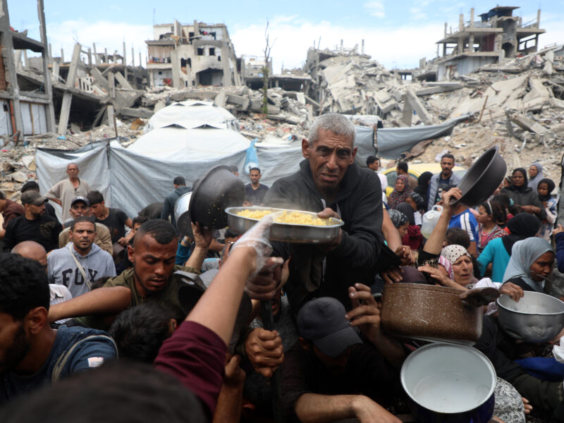 Palestinians receive free food from a food distribution center in the town of Beit Lahia, northern Gaza, on April 27, 2025.