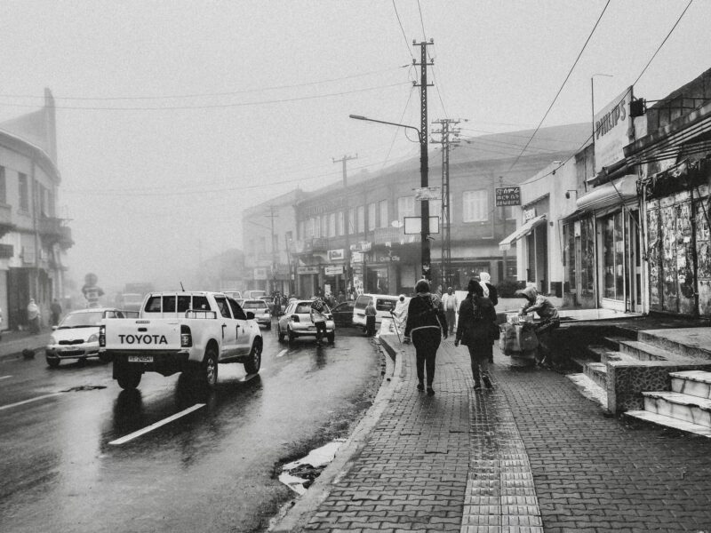 Grayscale photo of cars on road.