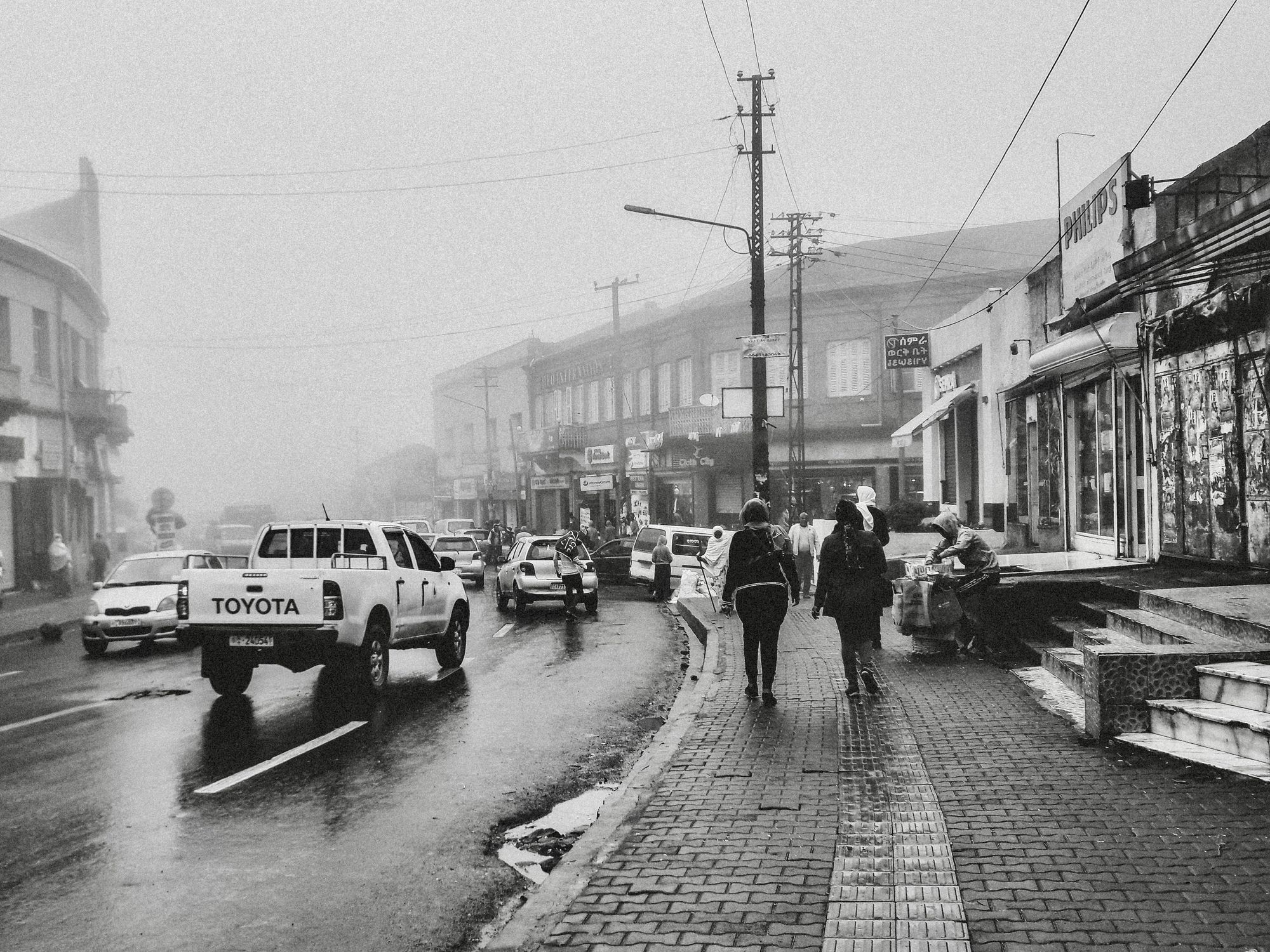 Grayscale photo of cars on road.