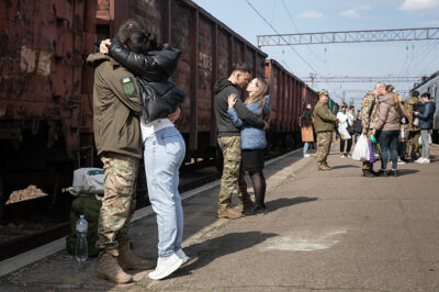 A military serviceman is seen embracing his sweetheart after a long time at the train station on the train platform in Kramatorsk, Ukraine