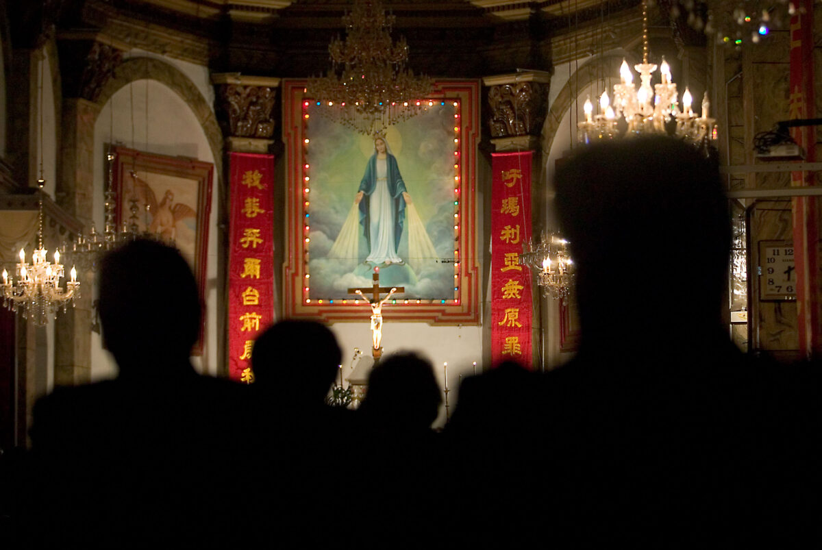 Chinese Catholic worshippers attend an early morning mass at the South Cathedral in Beijing in July 14, 2010