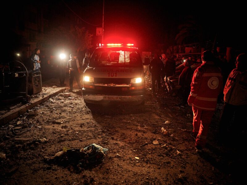 Photo of ​Palestinian Red Crescent ambulance and workers at night in Khan Younis, Gaza