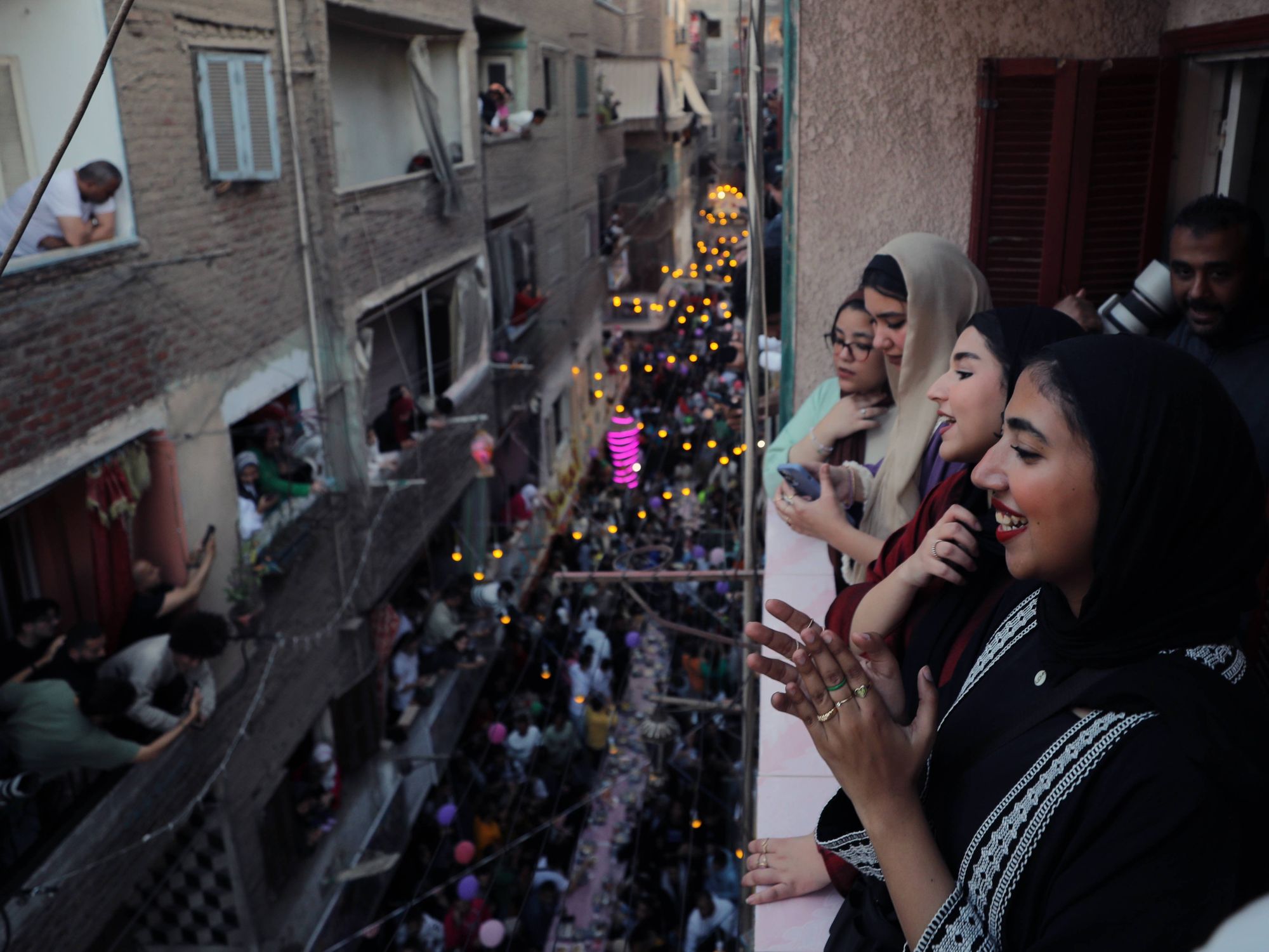Photo of Egyptian women and girls taking photos as they celebrate Iftar during Ramadan in Cairo