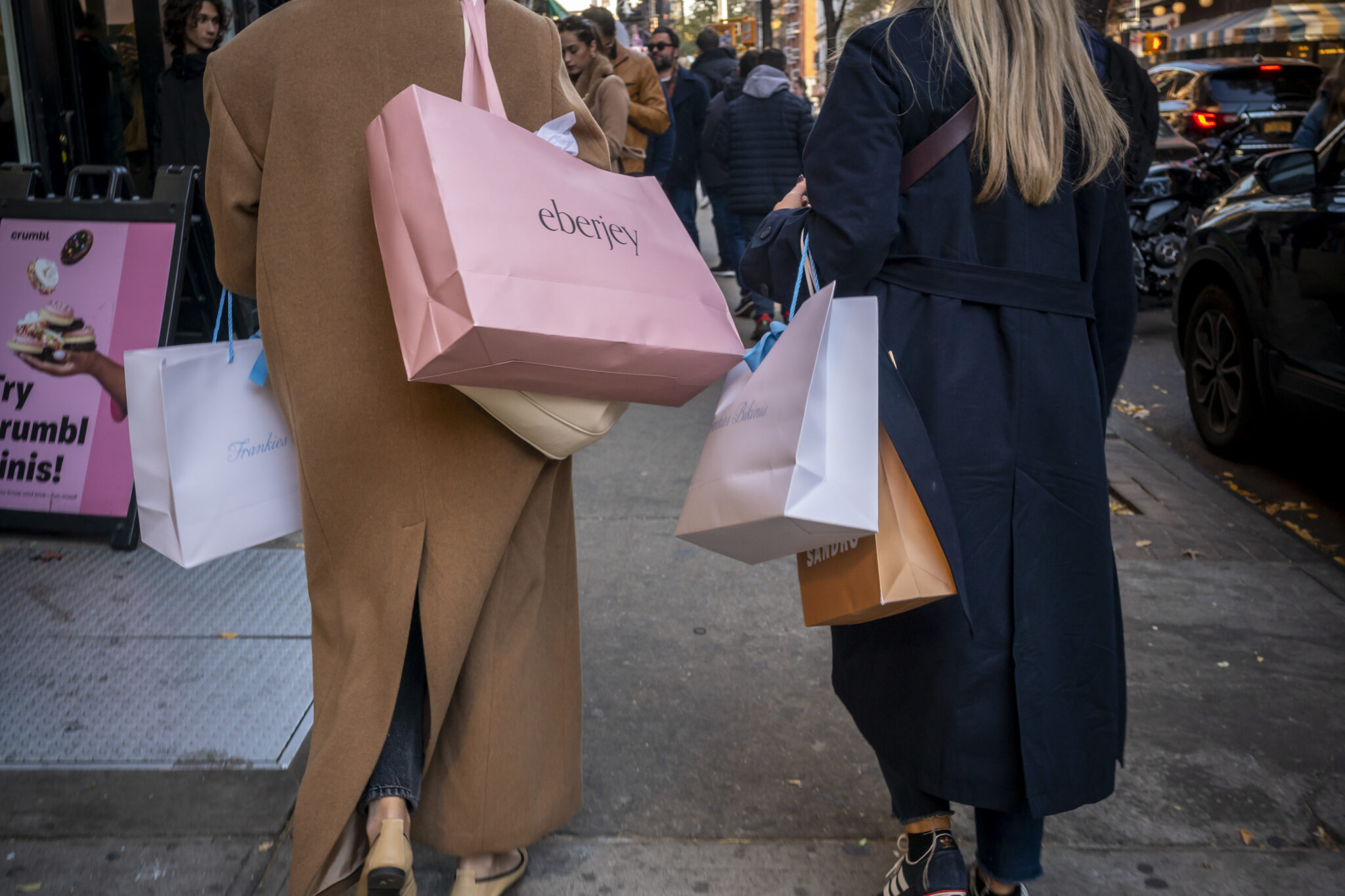 photo of women carrying shopping bags