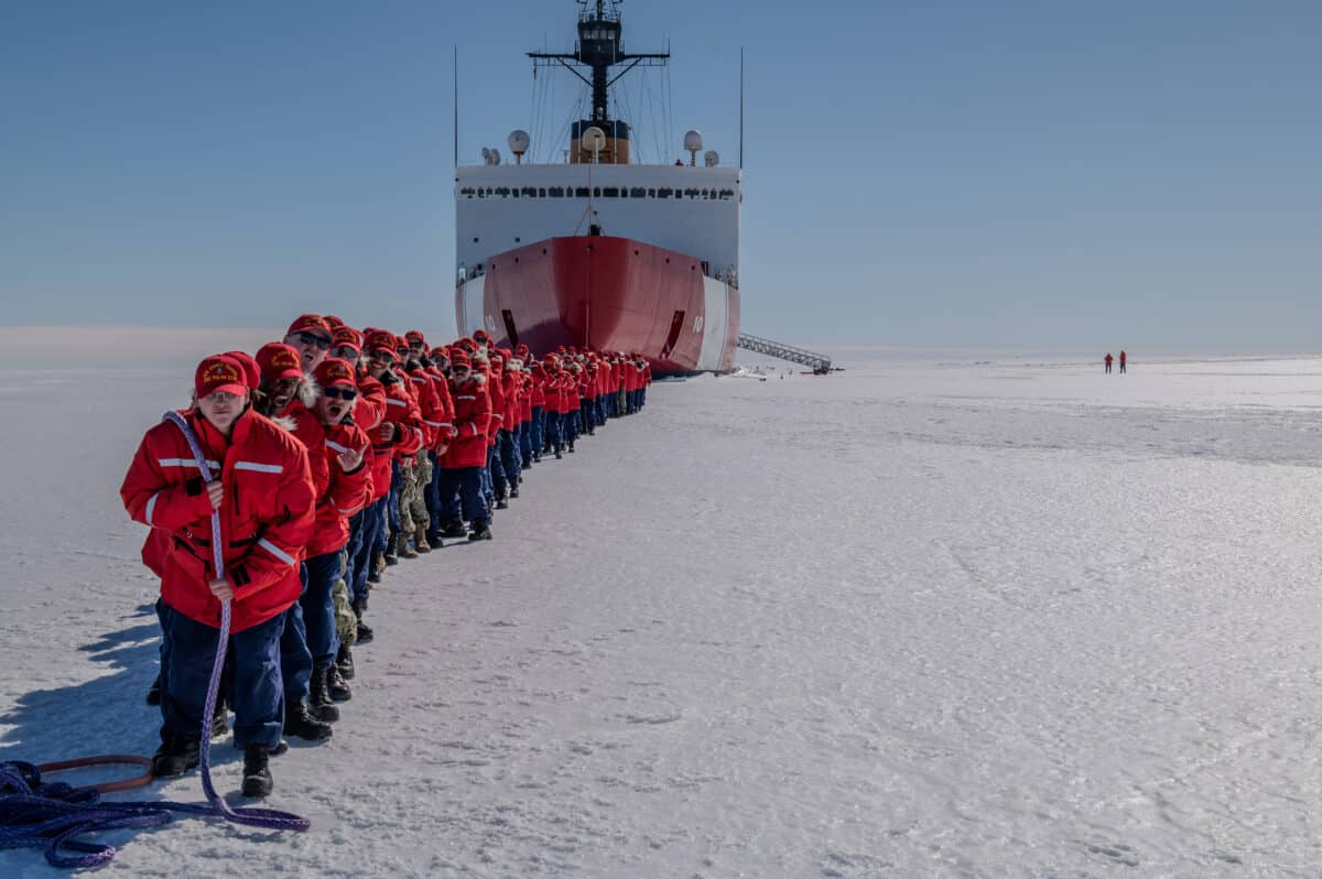 Photo of crew of the U.S. Coast Guard Cutter Polar Star (WAGB 10) towing the cutter while on the fast ice in McMurdo Sound, Antarctica.