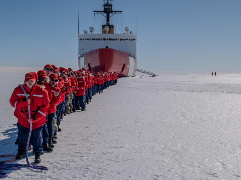Photo of crew of the U.S. Coast Guard Cutter Polar Star (WAGB 10) towing the cutter while on the fast ice in McMurdo Sound, Antarctica.