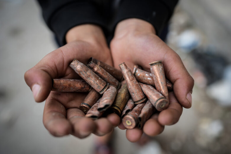 A person holds spent cartridges in Ashrafiyat Sahnaya, in the Rif Dimashq Governorate, following deadly clashes between members of the Druze minority and pro-government fighters.