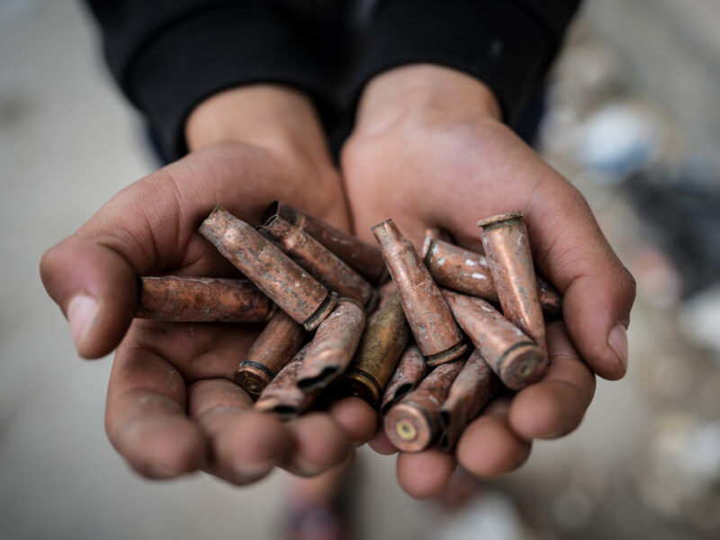A person holds spent cartridges in Ashrafiyat Sahnaya, in the Rif Dimashq Governorate, following deadly clashes between members of the Druze minority and pro-government fighters.