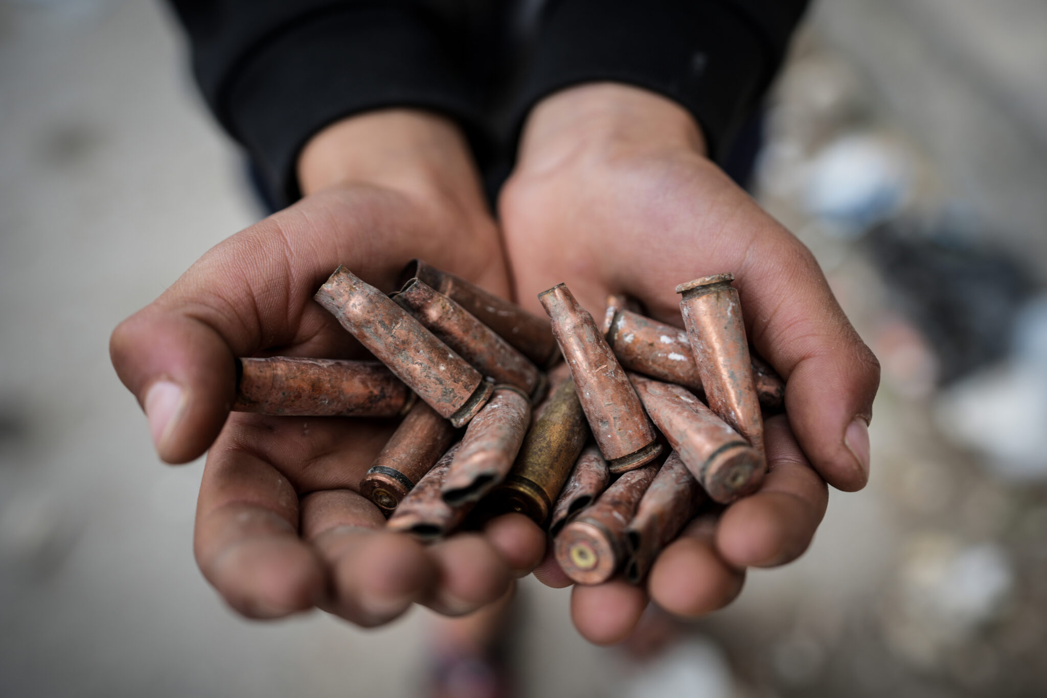 A person holds spent cartridges in Ashrafiyat Sahnaya, in the Rif Dimashq Governorate, following deadly clashes between members of the Druze minority and pro-government fighters.
