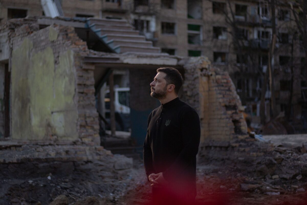 Ukrainian President Volodymir Zelensky stands amid rubble in Ukraine.