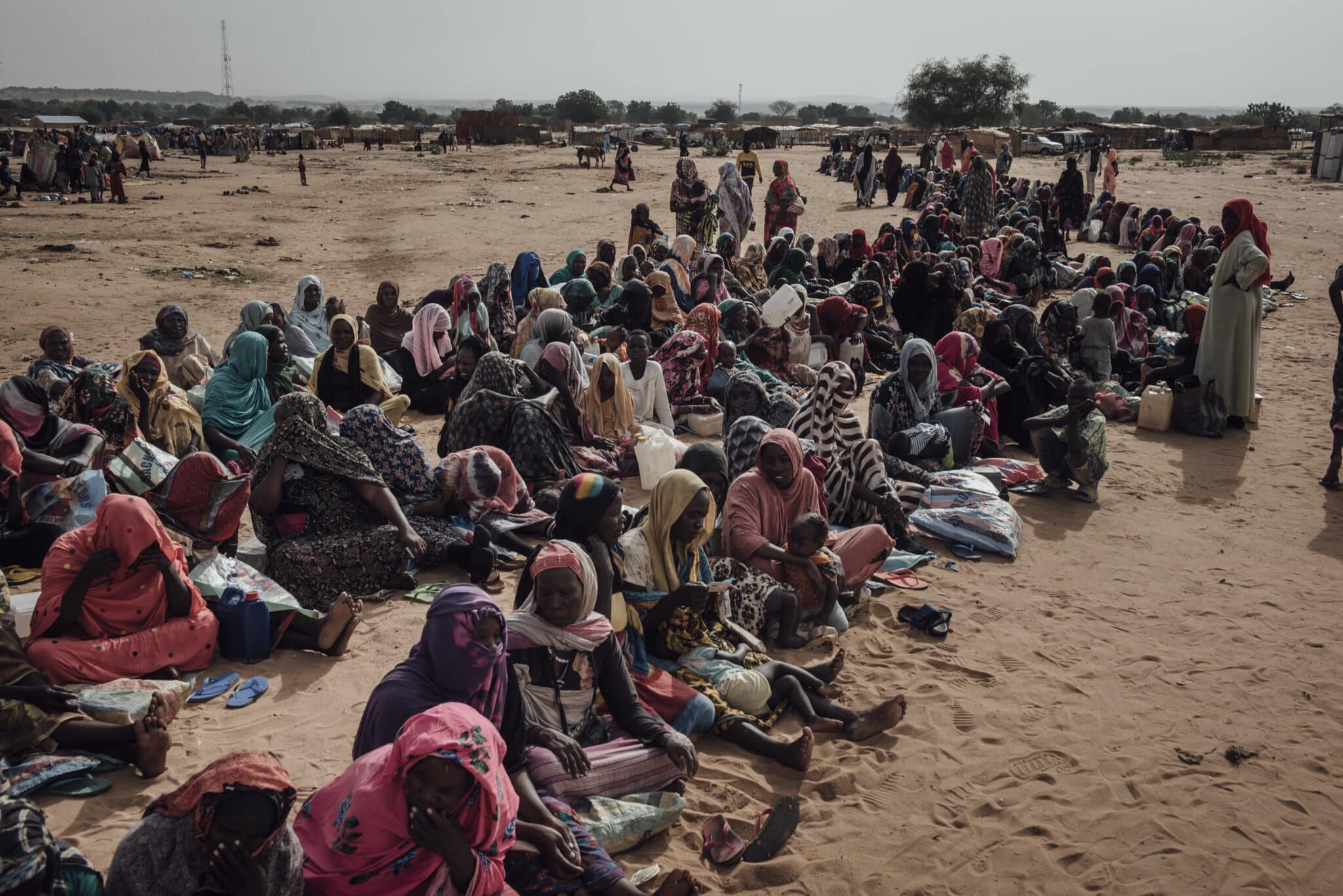 Sudanese women wait for the start of the monthly food distribution organized by UNHCR at Adre transit camp, Chad on June 24, 2024