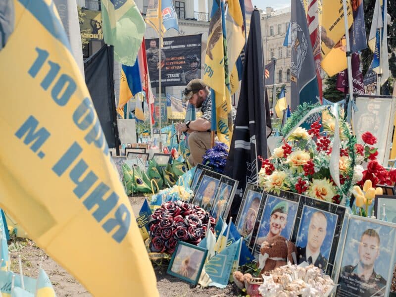 A soldier pays tribute to his fallen comrades at the Memorial in Maidan Square in Kyiv, Ukraine on May 14, 2025.