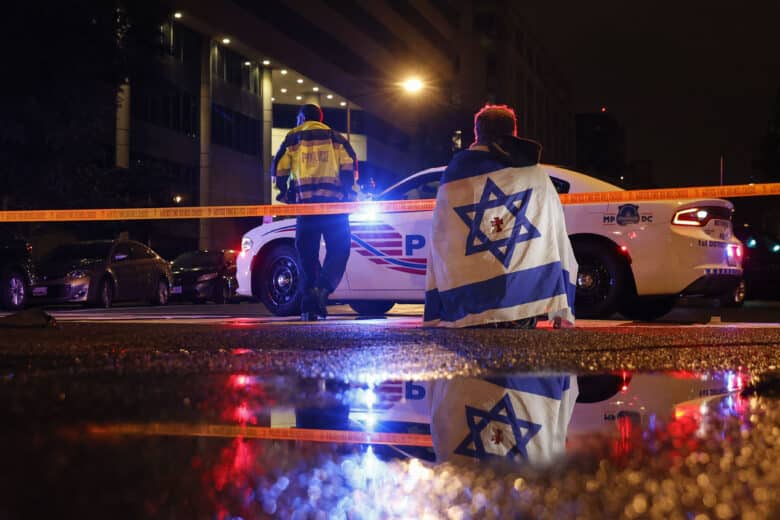A police officer cordons off the perimeter outside the Capital Jewish Museum in Washington, D.C., after two Israeli Embassy staff members were shot dead. Authorities have arrested a suspect, and the FBI is investigating the incident as a possible act of antisemitic terrorism.