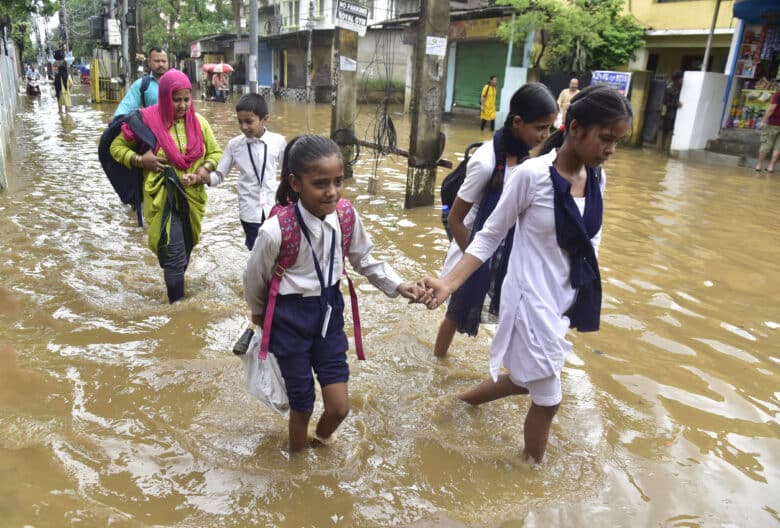 School students wade through water-logged streets after heavy downpours in Guwahati, in India's northeastern Assam state. Parts of India have experienced their wettest May in more than a century, with the unusually early arrival of the monsoon season causing a ferocious downpour.