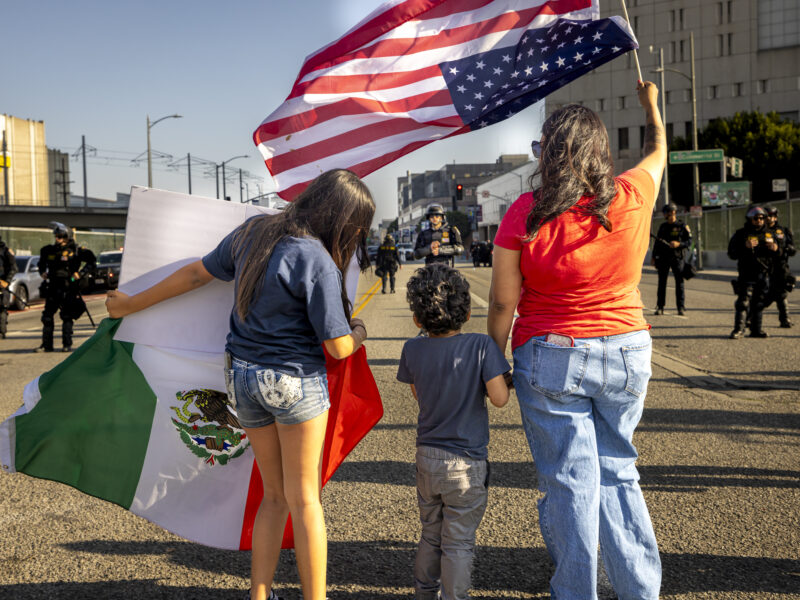 People with an upside-down American flag face off with police as protests continue following four days of clashes with police after immigration raids continue across the country on June 10, 2025, in Los Angeles, California, USA.