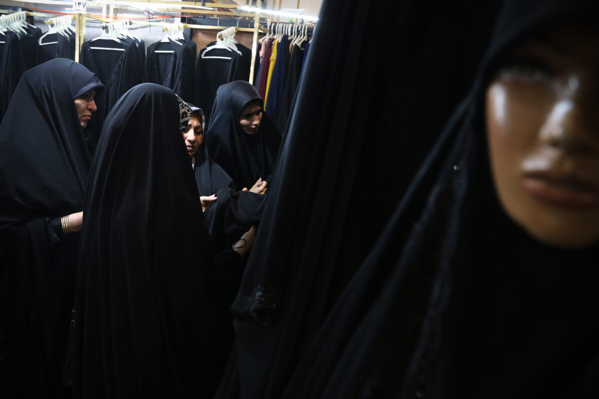 Iranian women look on black Chadors while visiting the Hijab and Chastity fair at the Imam Khomeini Grand Mosque in downtown Tehran, on March 31, 2024, Tehran, Iran.