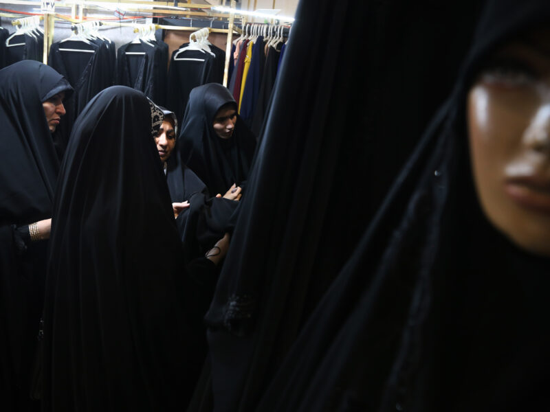 Iranian women look on black Chadors while visiting the Hijab and Chastity fair at the Imam Khomeini Grand Mosque in downtown Tehran, on March 31, 2024, Tehran, Iran.