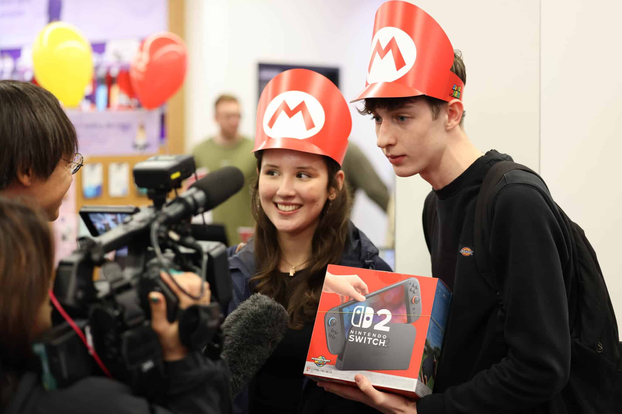 People in London collect their long-awaited Nintendo Switch 2 console, which launched worldwide on Wednesday with stores opening at midnight to accommodate record-breaking pre-orders. While some gaming fans may be deterred by the $449.99 price tag, others are eager to experience upgrades like better graphics, more storage and the new Mario Kart World game. Analysts see the Switch 2 as a strategic shift for Nintendo, offering familiar branding with appealing improvements like more support for third-party games, which could help it compete more directly with Sony and Microsoft.