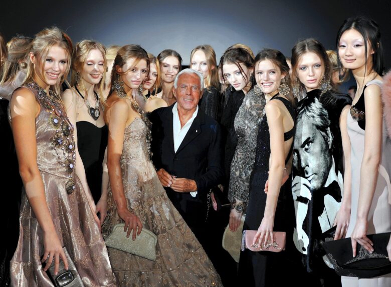 Designer Giorgio Armani poses with models at his fashion show in Milan, Italy on February 28, 2011.