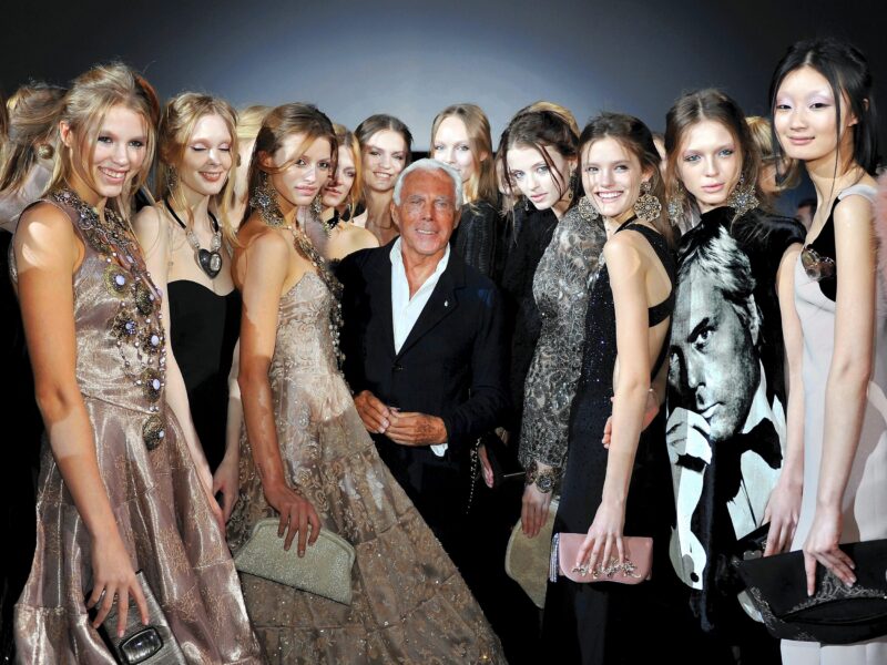 Designer Giorgio Armani poses with models at his fashion show in Milan, Italy on February 28, 2011.