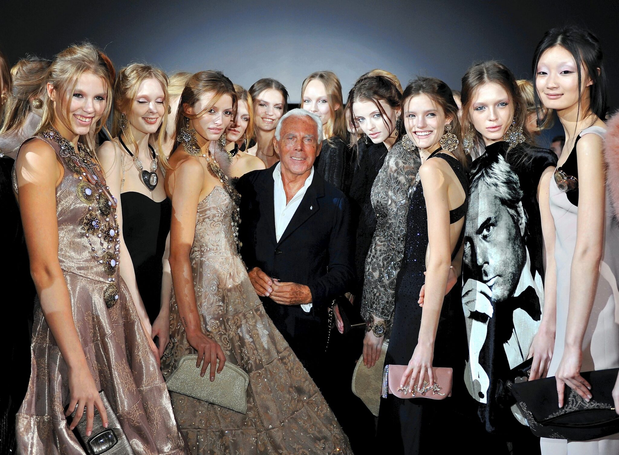 Designer Giorgio Armani poses with models at his fashion show in Milan, Italy on February 28, 2011.