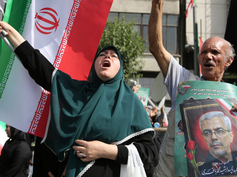 photo of iranian woman and flag
