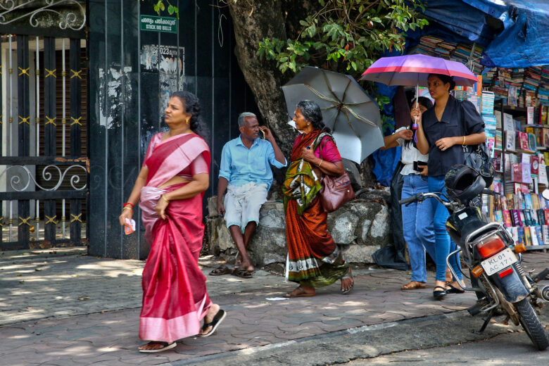 A woman using an umbrella to protect herself from the sun in Thiruvananthapuram, Kerala, India, on April 13, 2024.