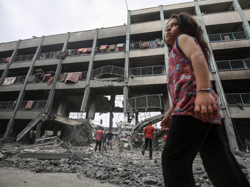 Palestinians inspect the destruction of Al-Falah School in the Zaytoun neighborhood after Israeli airstrikes reduced classrooms and shelter areas to rubble after missile strikes on Monday, leaving 74 people dead.