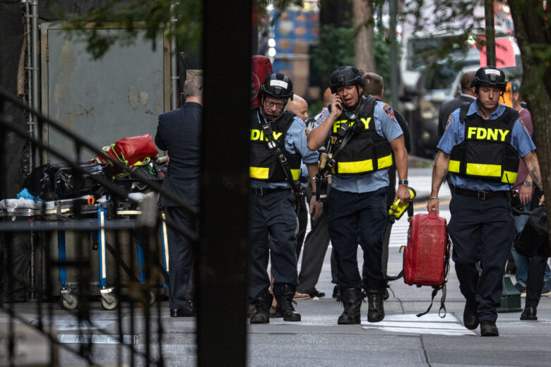 New York firefighters respond to an active shooting in midtown Manhattan on Monday, after a gunman identified as Shane Devon Tamura, 27, walked into a Park Avenue corporate building and opened fire, killing four people, including a policeman, and then shot and killed himself. Law enforcement officials believe the suspect acted alone.