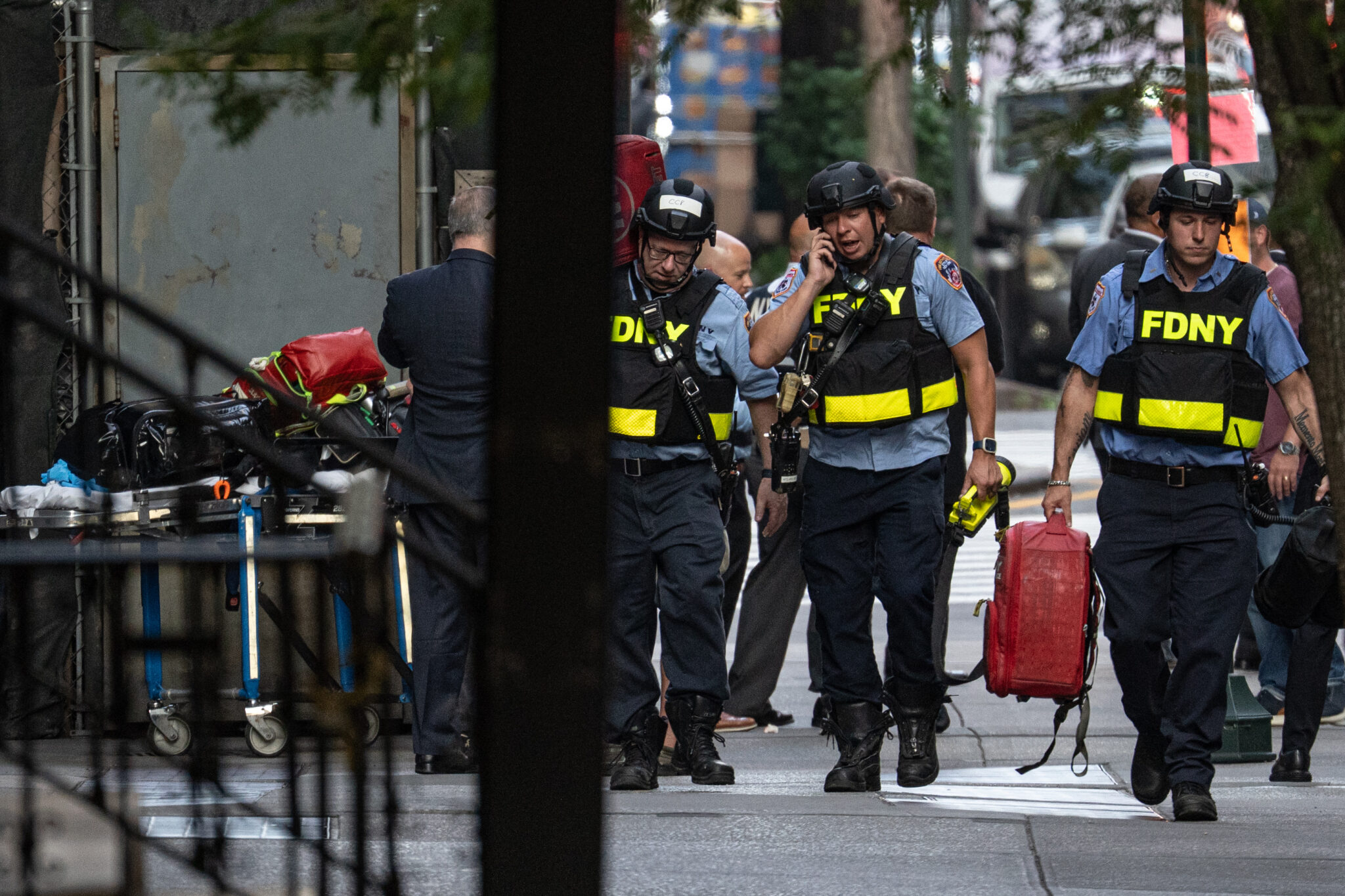 New York firefighters respond to an active shooting in midtown Manhattan on Monday, after a gunman identified as Shane Devon Tamura, 27, walked into a Park Avenue corporate building and opened fire, killing four people, including a policeman, and then shot and killed himself. Law enforcement officials believe the suspect acted alone.
