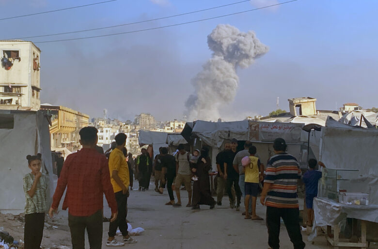 Smoke billowing in the aftermath of an Israeli strike on a house in Eastern Gaza City late Wednesday. Israeli attacks have continued throughout the night, killing at least 94 Palestinians, including 45 aid seekers, since dawn on Thursday.