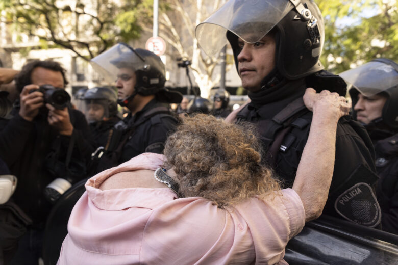 A woman pleads with a police officer during a mobilization demanding increased pension income and access to medicines in Buenos Aires, Argentina. Retirees and supporters have been holding weekly protests in the capital against libertarian President Javier Milei’s austerity measures, launched shortly after he took office in December 2023.