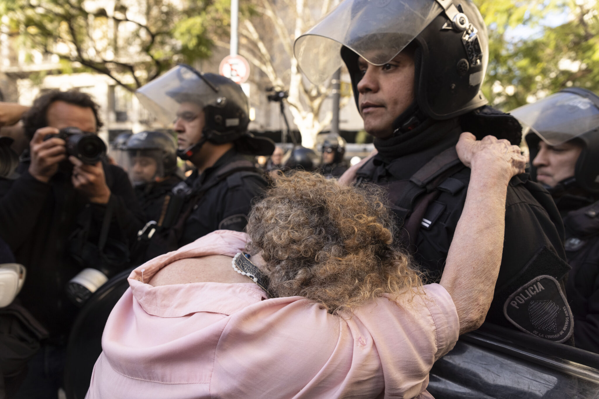 A woman pleads with a police officer during a mobilization demanding increased pension income and access to medicines in Buenos Aires, Argentina. Retirees and supporters have been holding weekly protests in the capital against libertarian President Javier Milei’s austerity measures, launched shortly after he took office in December 2023.
